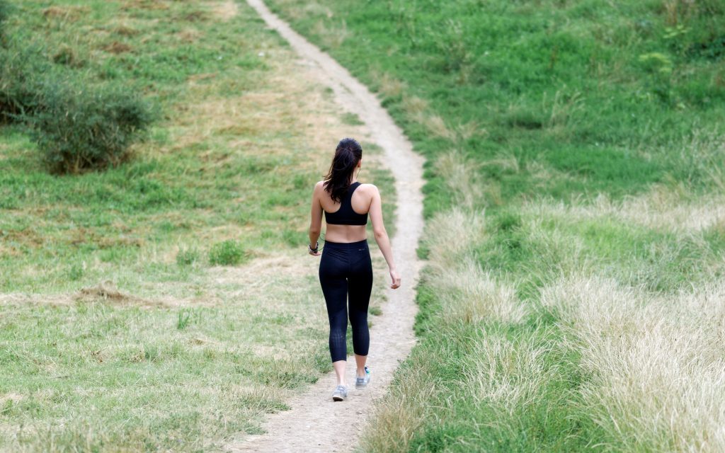 woman walking down a trail